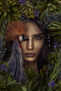 Close-up portrait of woman with purple flowers