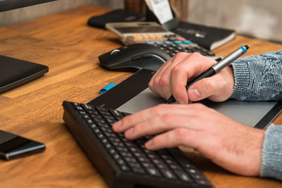 Midsection of woman using laptop on table