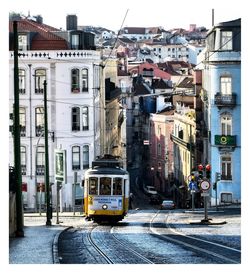 Cars on street amidst buildings in city