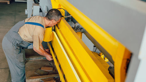 Side view of man working at construction site