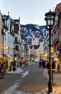 Street amidst buildings in city against clear sky