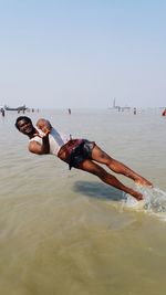 People at beach against sky