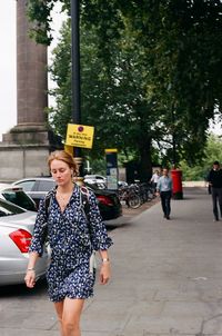 Full length of woman looking away in city