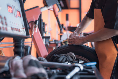 Midsection of man repairing car