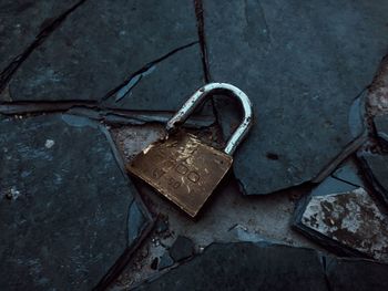 Close-up of padlocks hanging on rusty metal