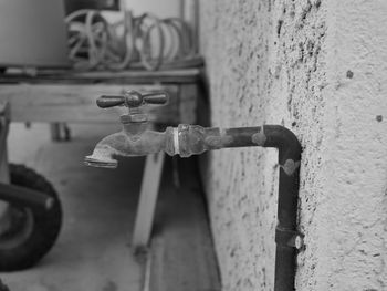 Close-up of faucet against wall