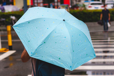 Umbrella on wet street during monsoon