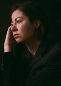 Close-up portrait of a young woman looking away