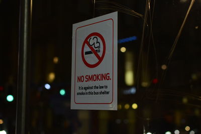 Close-up of information sign at night