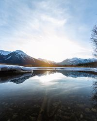 Scenic view of lake and snowcapped mountains against sky