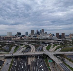 High angle view of highway by buildings in city against sky