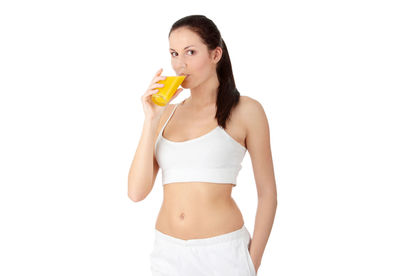 Midsection of woman standing against white background