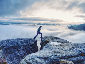 Man on successful hiking trip, silhouette in low mountains of saxony switzerland. hiker on top