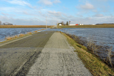 Road by sea against sky