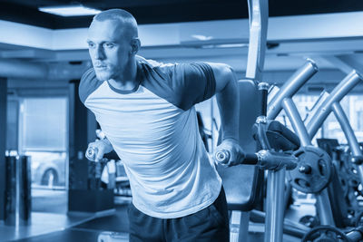 Portrait of young man exercising in gym