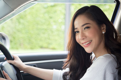 Portrait of beautiful woman in car