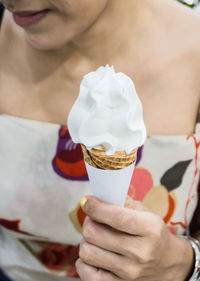 Midsection of woman holding ice cream