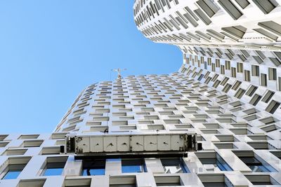 Low angle view of modern building against clear blue sky