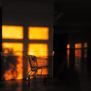 Sunlight falling on shopping cart in empty corridor