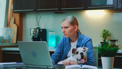 Young woman using laptop at home