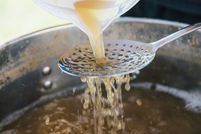 Close-up of ice pouring in water