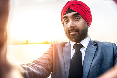 Portrait of businessman wearing turban by river