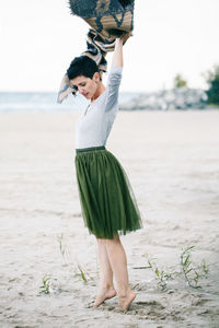 Woman standing on sand at beach