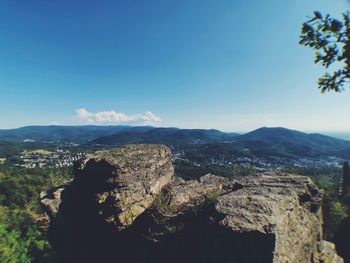 Scenic view of mountains against blue sky