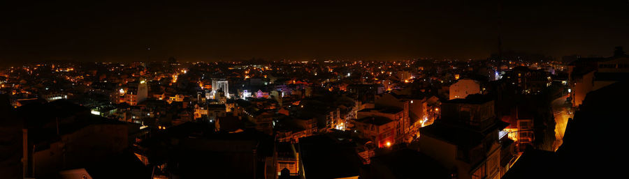 High angle view of illuminated townscape against sky at night