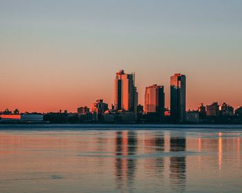 View of city at waterfront during sunset