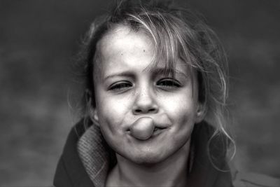 Close-up portrait of cute girl eating candy