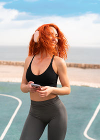Young woman exercising at beach