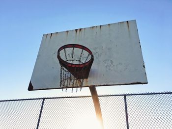 Low angle view of basketball hoop against clear sky