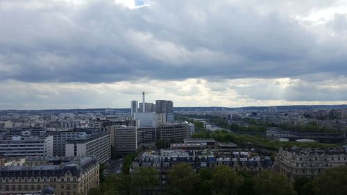 Cityscape against cloudy sky