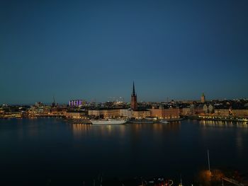 Illuminated city at waterfront