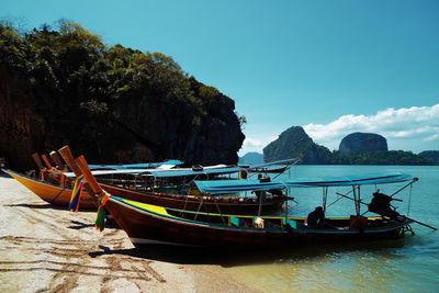 Boats moored on sea against sky