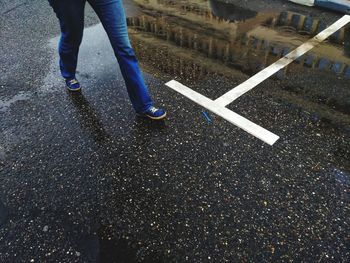 Low section of man standing on street