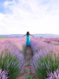 Rear view of woman standing on land