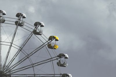 Low angle view of ferris wheel against sky