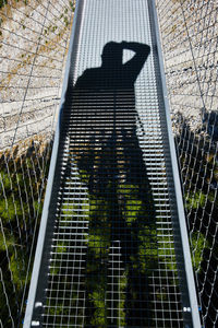 High angle view of woman standing on metal structure