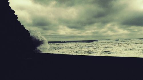 Scenic view of sea against cloudy sky