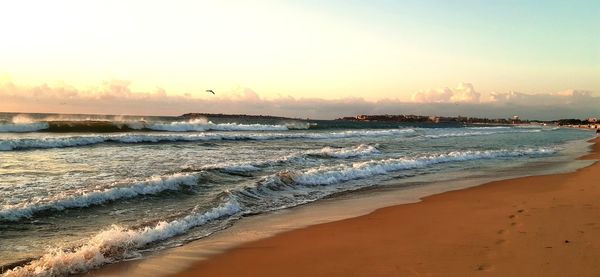 Scenic view of beach against sky during sunset