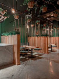 Empty chairs and tables in illuminated room