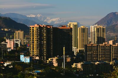 Buildings in city against sky