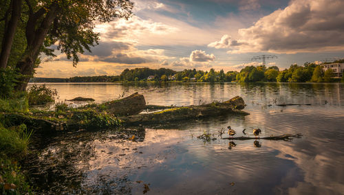 Scenic view of lake against sky during sunset