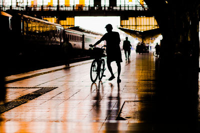 Silhouette man walking on wet floor