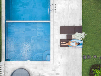 Aerial view of attractive woman near the pool at resort