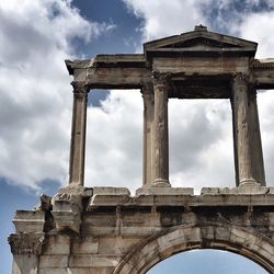 Low angle view of old building against cloudy sky