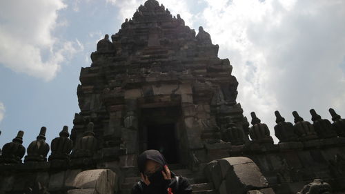 People at temple against sky