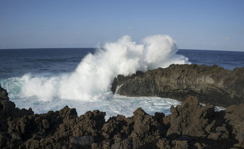 Scenic view of sea waves against clear sky